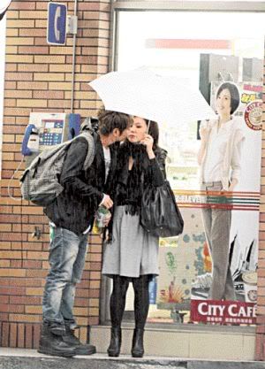 couple holding hands in rain. holding hands and shopping